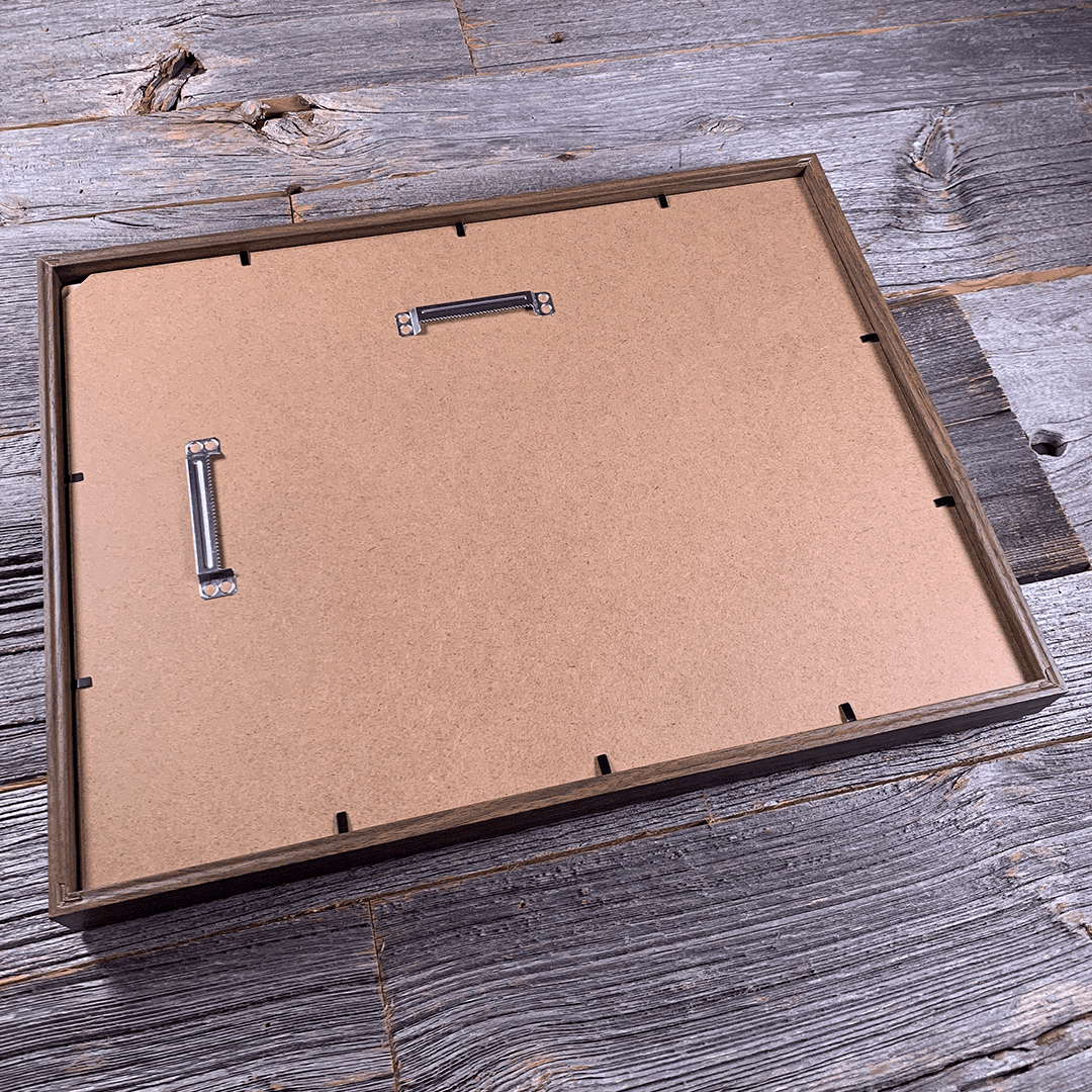 Rear view of framed laser-engraved wooden wall art showing dual metal sawtooth hangers and secure back panel construction. Designed for easy horizontal or vertical hanging and long-term durability.