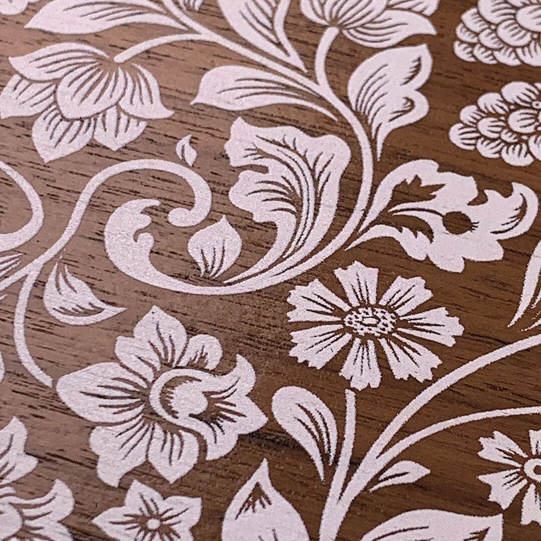 Zoomed in detailed shot of the Blossom white-painted pattern on Walnut Wood