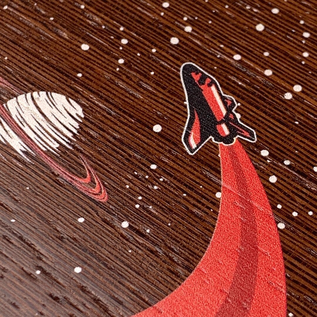 Zoomed in detailed shot of the stylized space shuttle boosting to saturn printed on Wenge wood phone case by Keyway