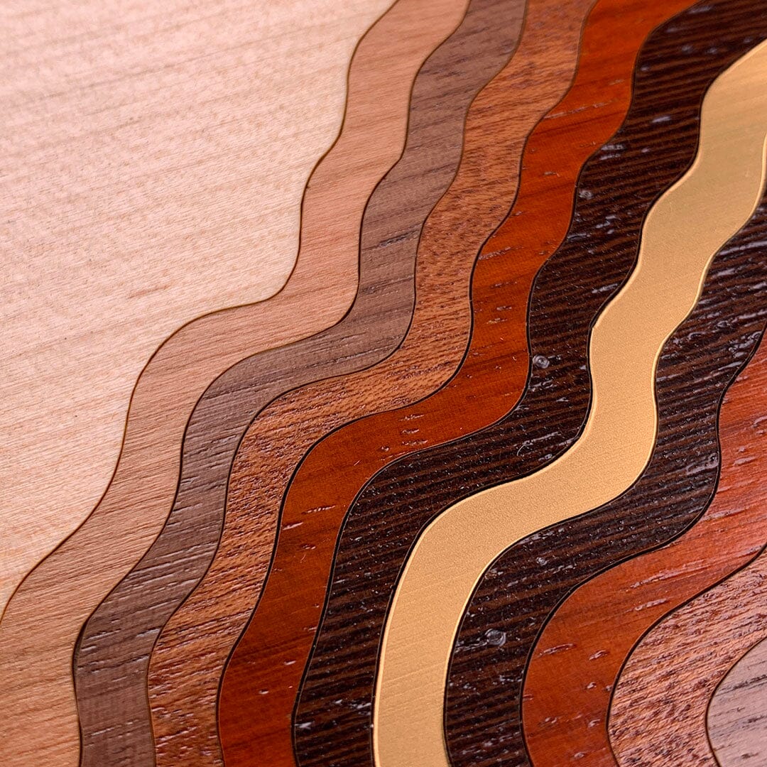 Zoomed in detailed shot of the Canyon case featuring a tight pattern of Walnut, Wenge, Maple, and Padauk wood