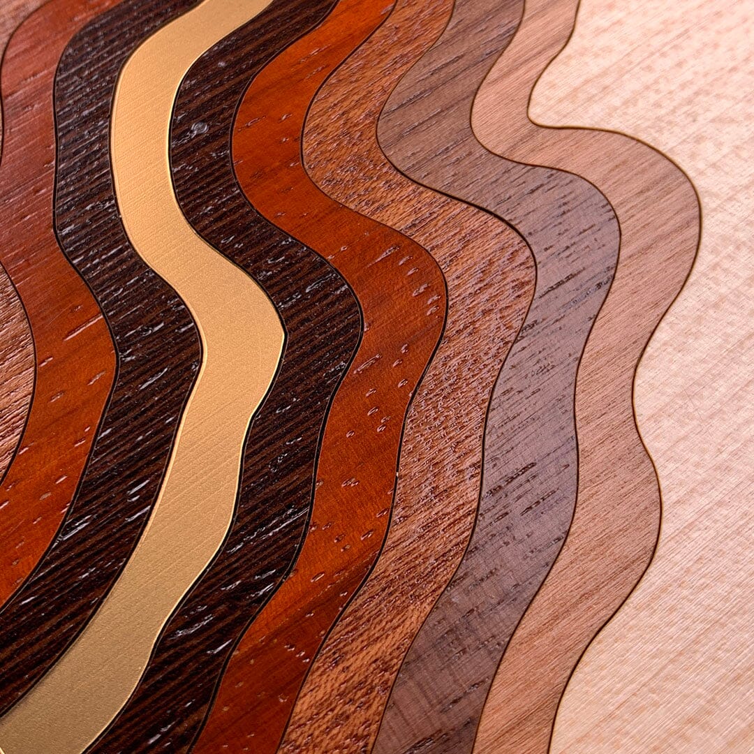 Head-on zoomed in detailed shot of the Canyon case featuring a tight pattern of Walnut, Wenge, Maple, and Padauk wood