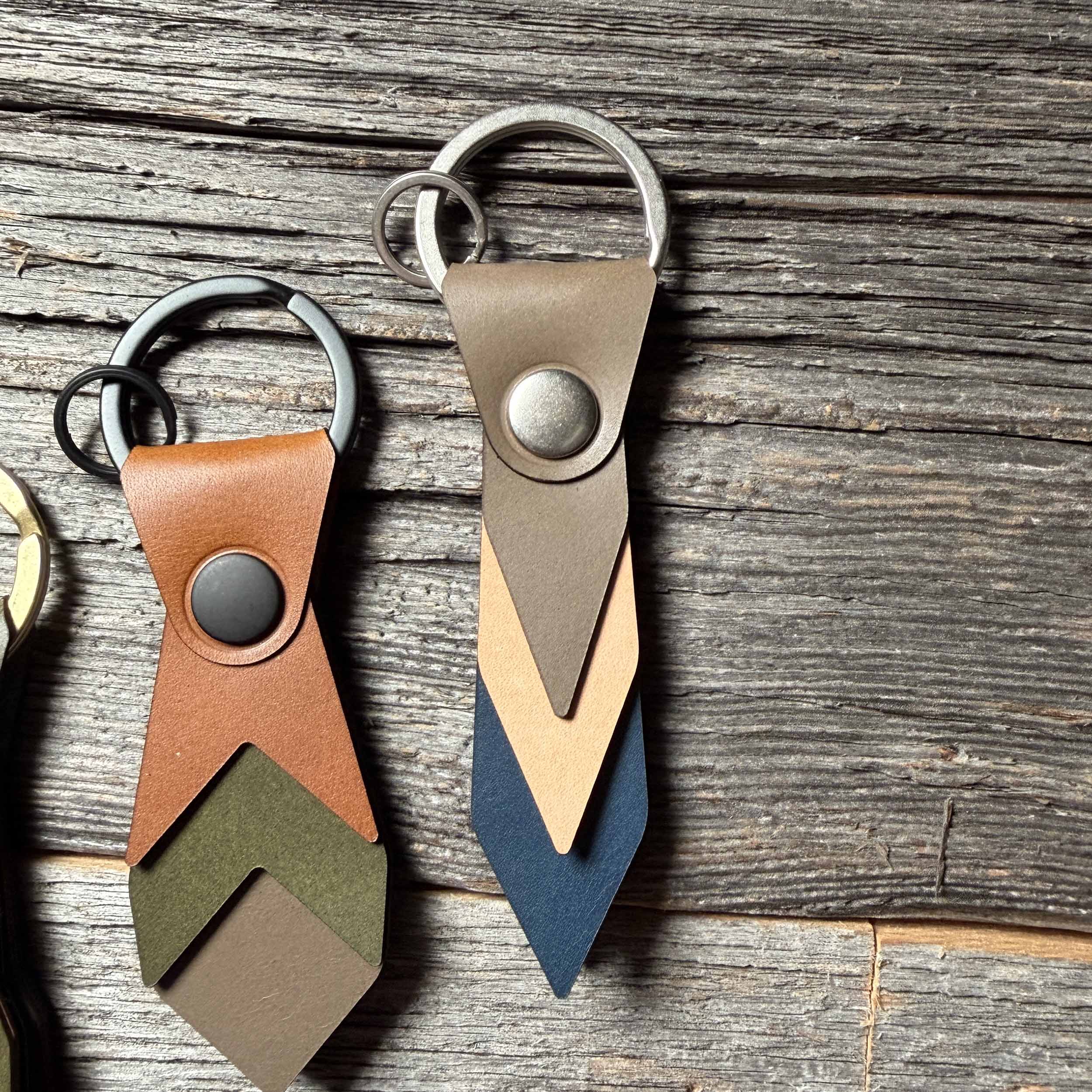 Driftwood leather keychain styled on weathered wood beside other Keyway full-grain veg-tan colorways