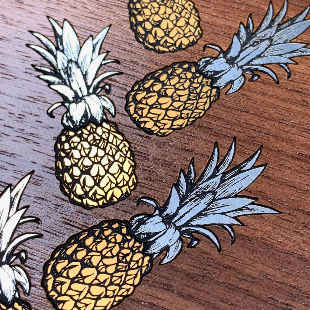 Zoomed in detailed shot of the Pineapple Case featuring a repeating gold and silver Pineapple inlay on a Walnut Wood backer