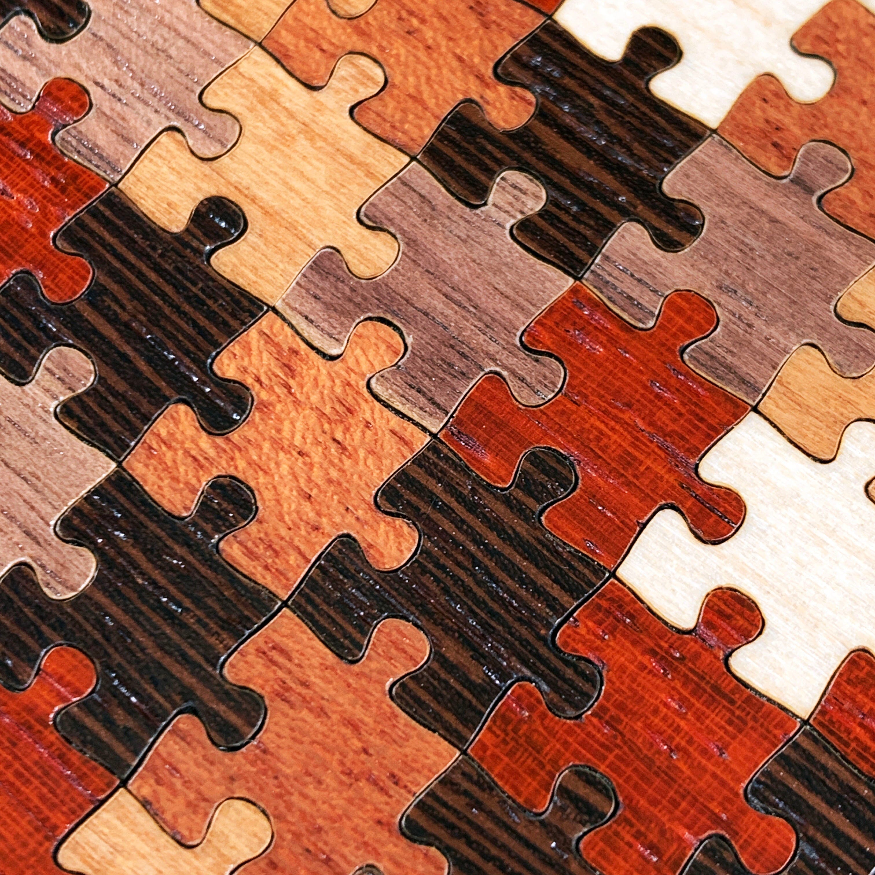Zoomed in detail shot of the Wenge, Maple, Cherry, Walnut and Padauk puzzle pieces wood phone case by Keyway
