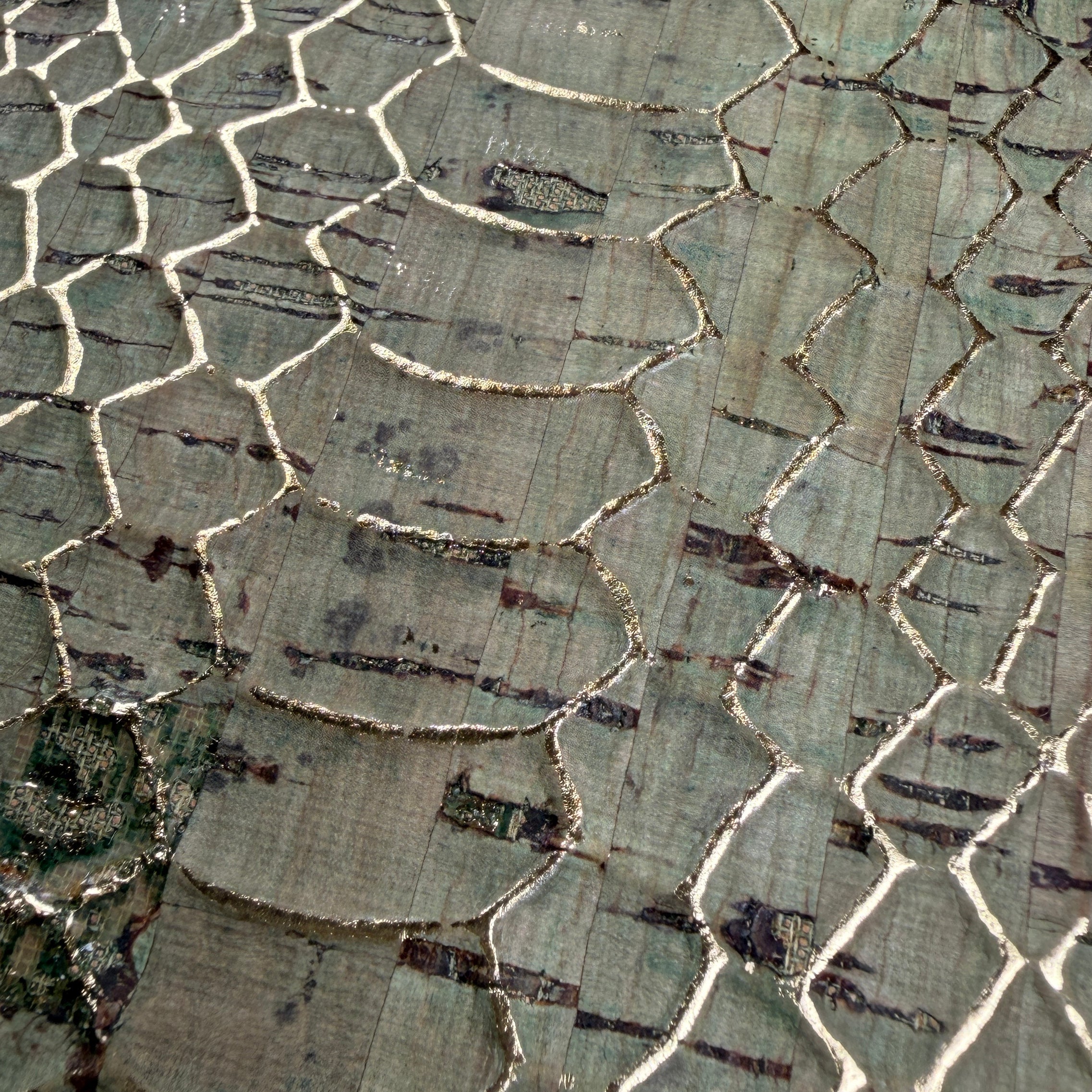 Zoomed details of the gold foil highlights between embossed snake skin details on the Python Cork phone case by Keyway