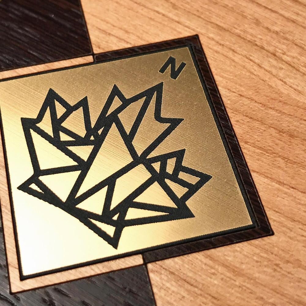 Zoomed in detail shot of the True North gold geometric maple leaf inlay on cherry and wenge wood phone case by Keyway