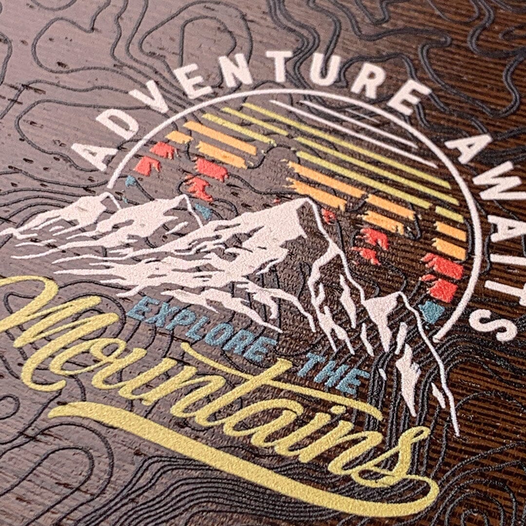 Zoomed in detail shot of the Wanderlust mountains and sunset adventure logo printed on Wenge wood phone case by Keyway