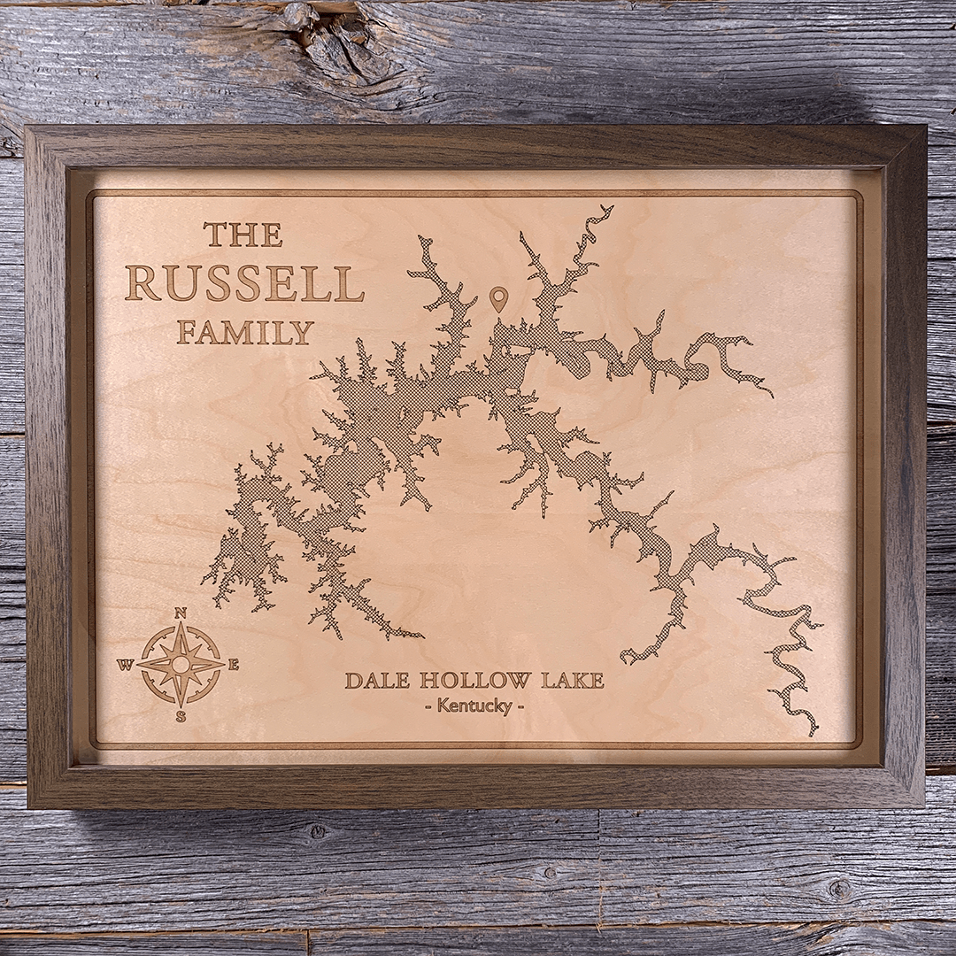 Framed laser-engraved wood map of Dale Hollow Lake in Kentucky, personalized with family name. Crafted from natural maple and set in a dark wood frame, this rustic wall art is perfect for lake homes, cabins, and meaningful family gifts.