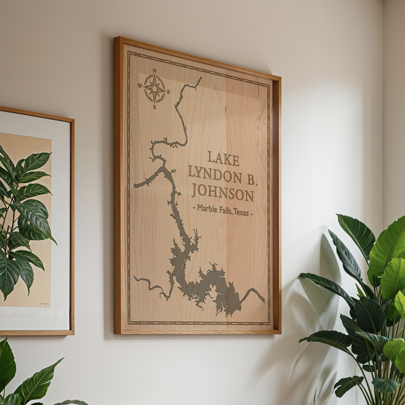 Framed laser-engraved map of Lake Lyndon B. Johnson in Marble Falls, Texas, displayed in a bright, modern living space. The natural maple wood and elegant linework make this wall art a perfect addition to contemporary or nature-inspired home décor.