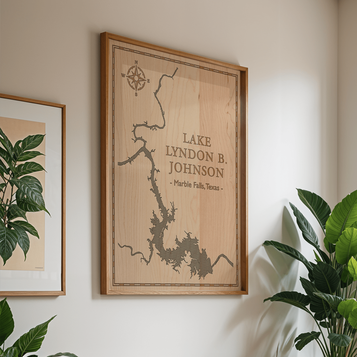 Framed laser-engraved map of Lake Lyndon B. Johnson in Marble Falls, Texas, displayed in a bright, modern living space. The natural maple wood and elegant linework make this wall art a perfect addition to contemporary or nature-inspired home décor.