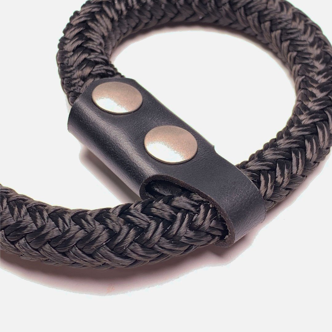 Camera Wrist Strap. Black Leather, Brass and Black Nylon. Slip-knot style wrist closure.