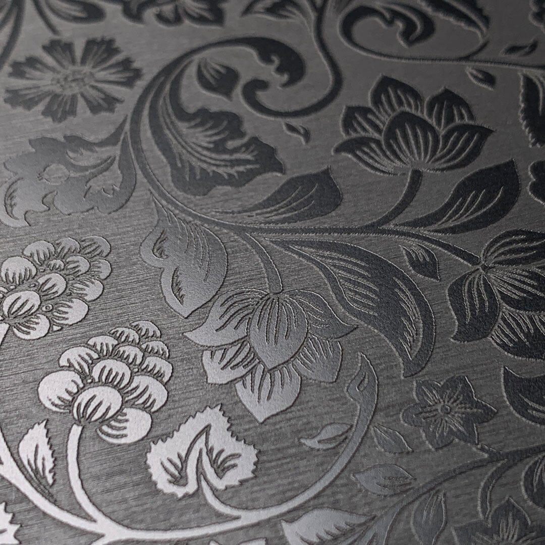 Zoomed in detailed shot of the highly detailed midnight floral engraving on matte black impact acrylic iPhone 15 Pro MagSafe Case by Keyway Designs