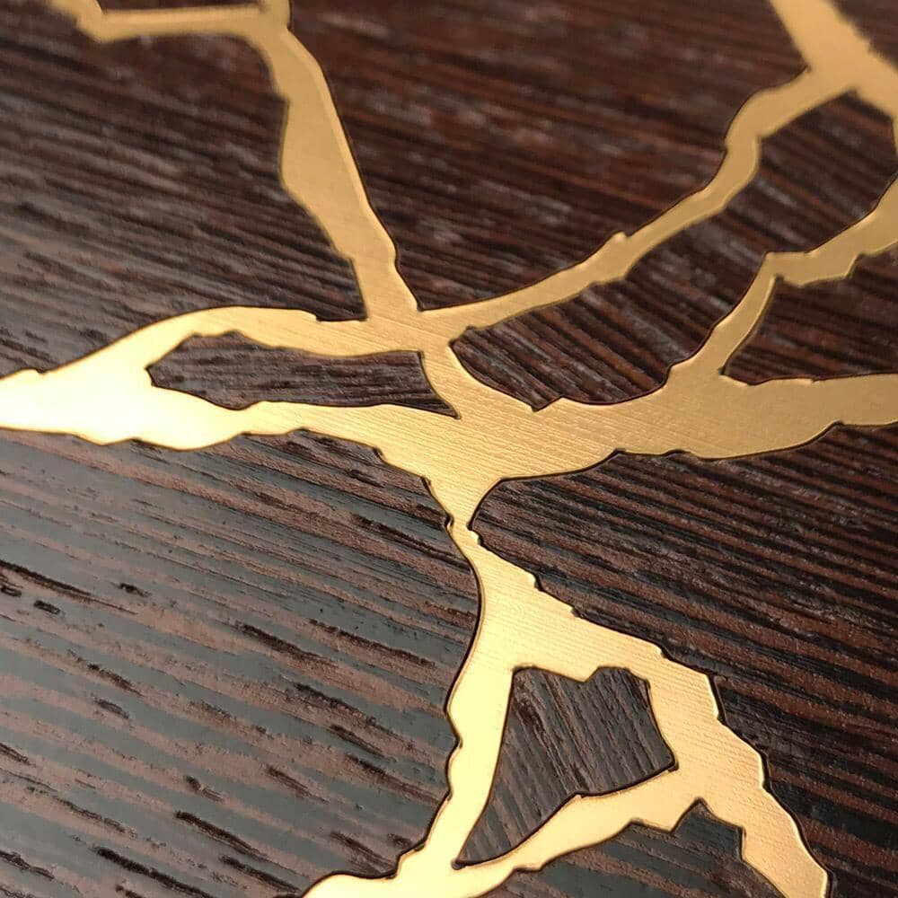 Zoomed in detailed shot of the Kintsugi inspired Gold and Wenge Wood iPhone 15 Pro MagSafe Case by Keyway Designs