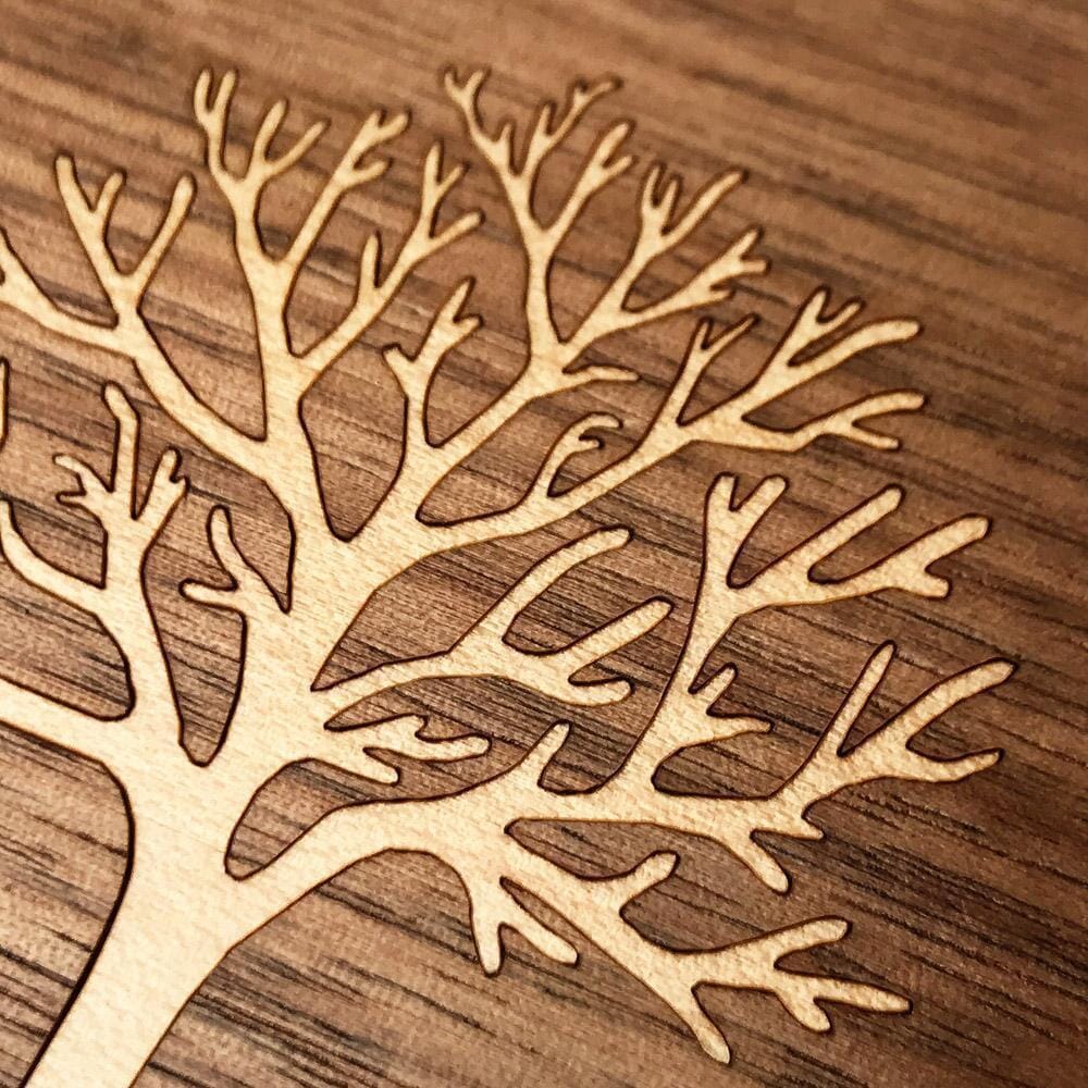 Zoomed in detailed shot of the Tree Of Life Walnut Wood iPhone 15 Pro MagSafe Case by Keyway Designs