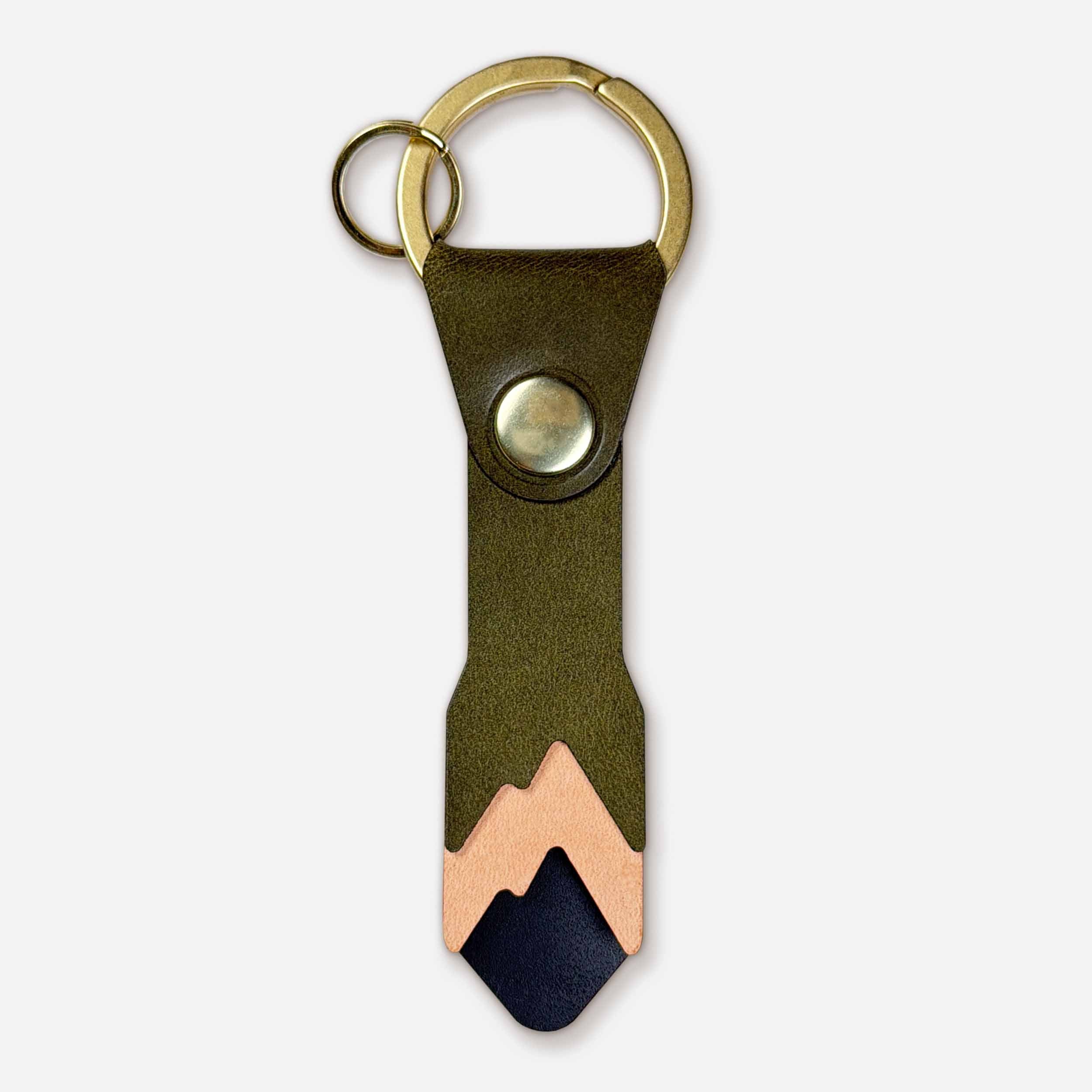 Front view of Keyway Alpine leather keychain showing snowcap mountain peak in olive, natural, and black