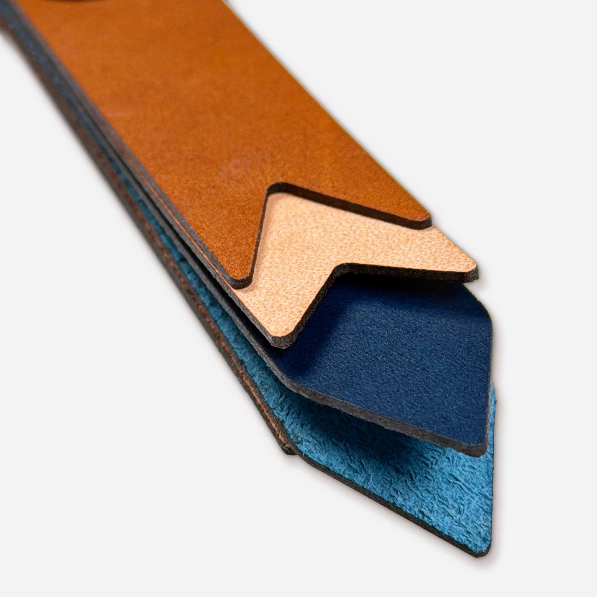 Close-up of Horizon leather keychain showing layered Italian full-grain veg-tan in whiskey, natural, and midnight