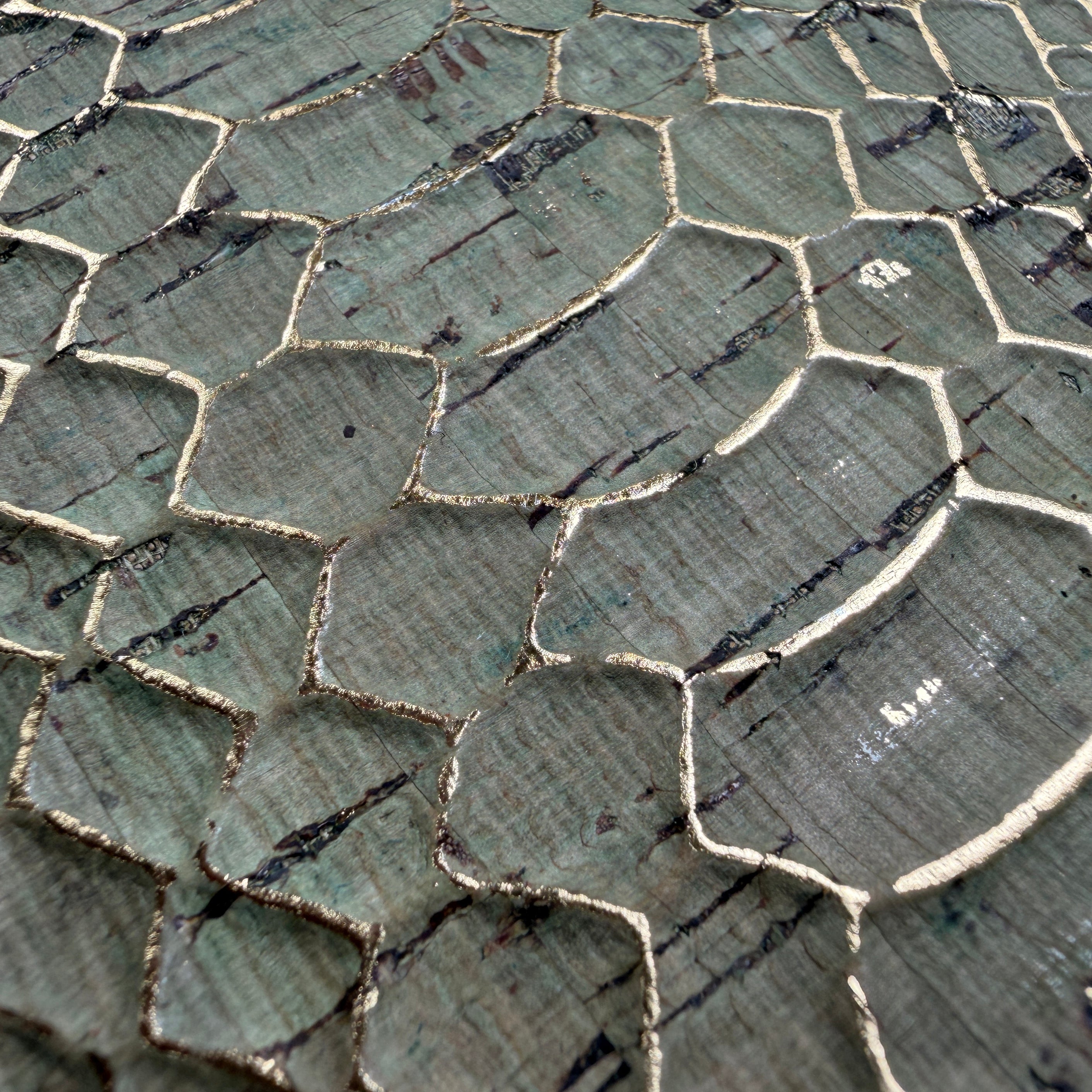 Zoomed details of the gold foil highlights between embossed snake skin details on the Python Cork phone case by Keyway