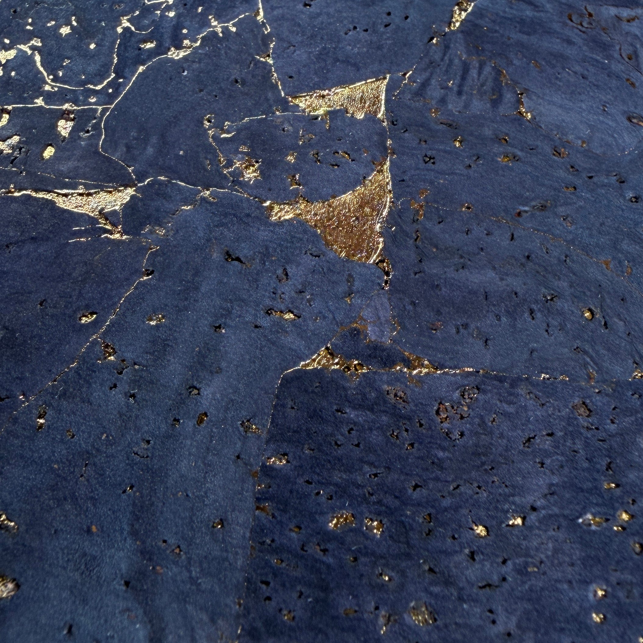Zoomed details of the gold foil flakes between layers of deep blue cork in the Quartz Cork phone case by Keyway