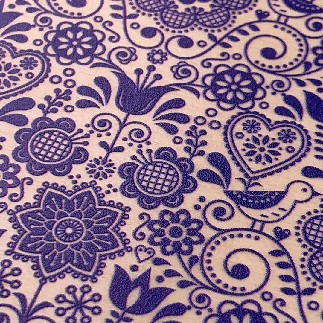Zoomed in detailed shot of the blue floral pattern on maple wood iPhone 15 Plus MagSafe Case by Keyway Designs