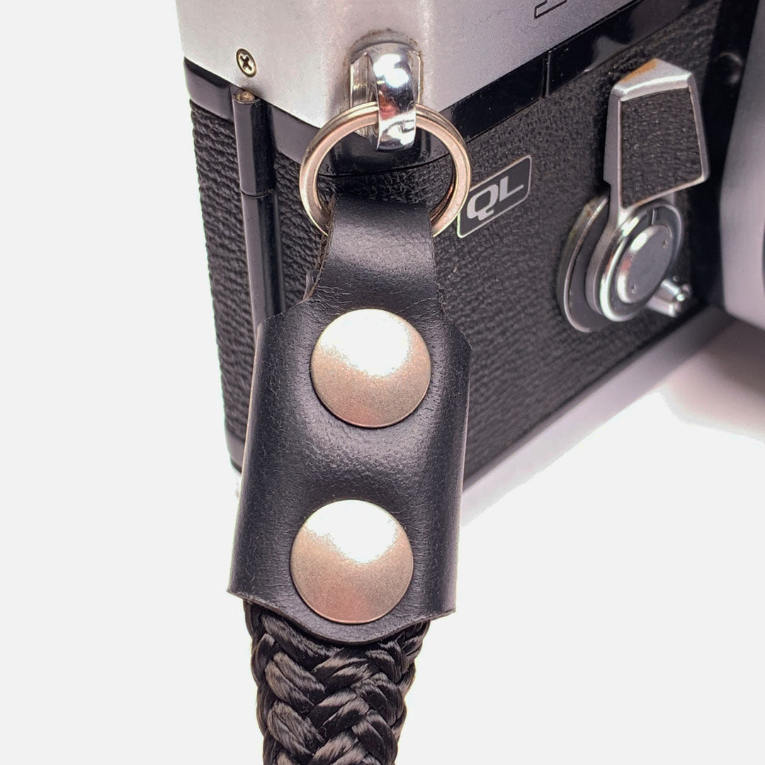 Camera Wrist Strap. Black Leather, Brass and Black Nylon. Precision cut leather and solid brass hardware.
