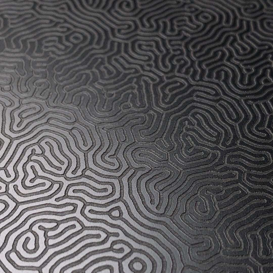 Zoomed in detailed shot of the highly detailed organic growth engraving on matte black impact acrylic iPhone 13 MagSafe Case by Keyway Designs
