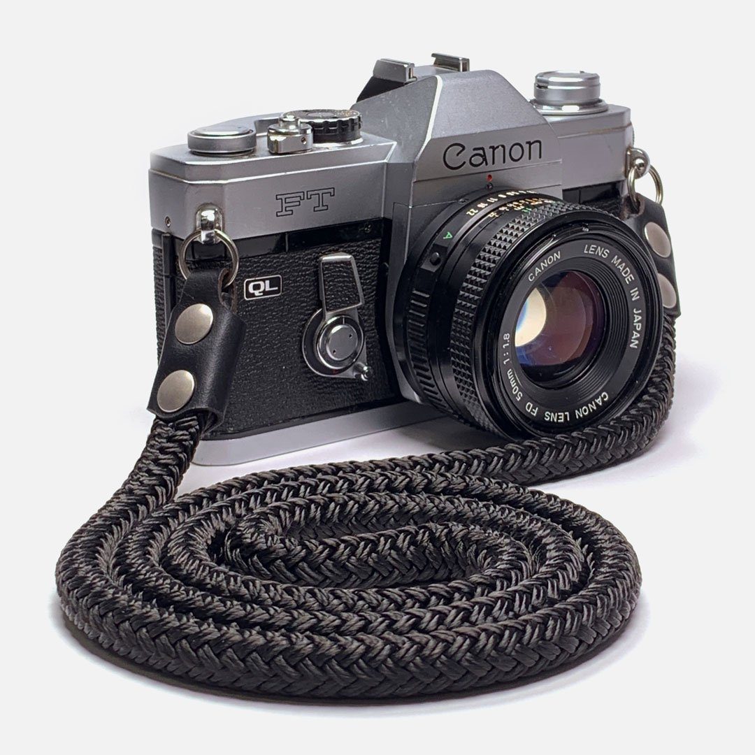 Camera Neck Strap. Black Leather, Brass and Black Nylon. Designed to hand below the chest.