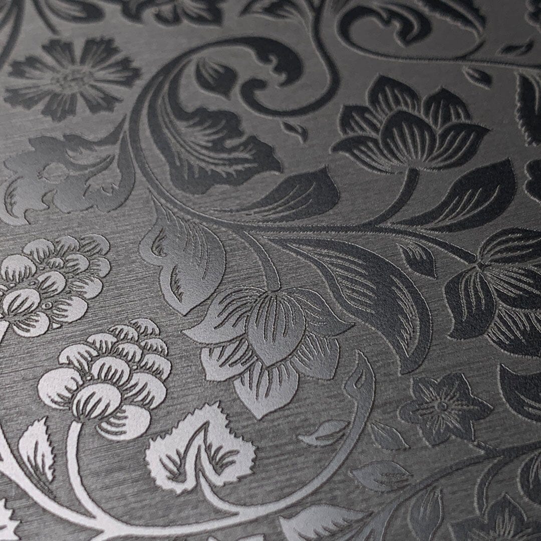 Zoomed in detailed shot of the highly detailed midnight floral engraving on matte black impact acrylic iPhone 13 Mini Case by Keyway Designs