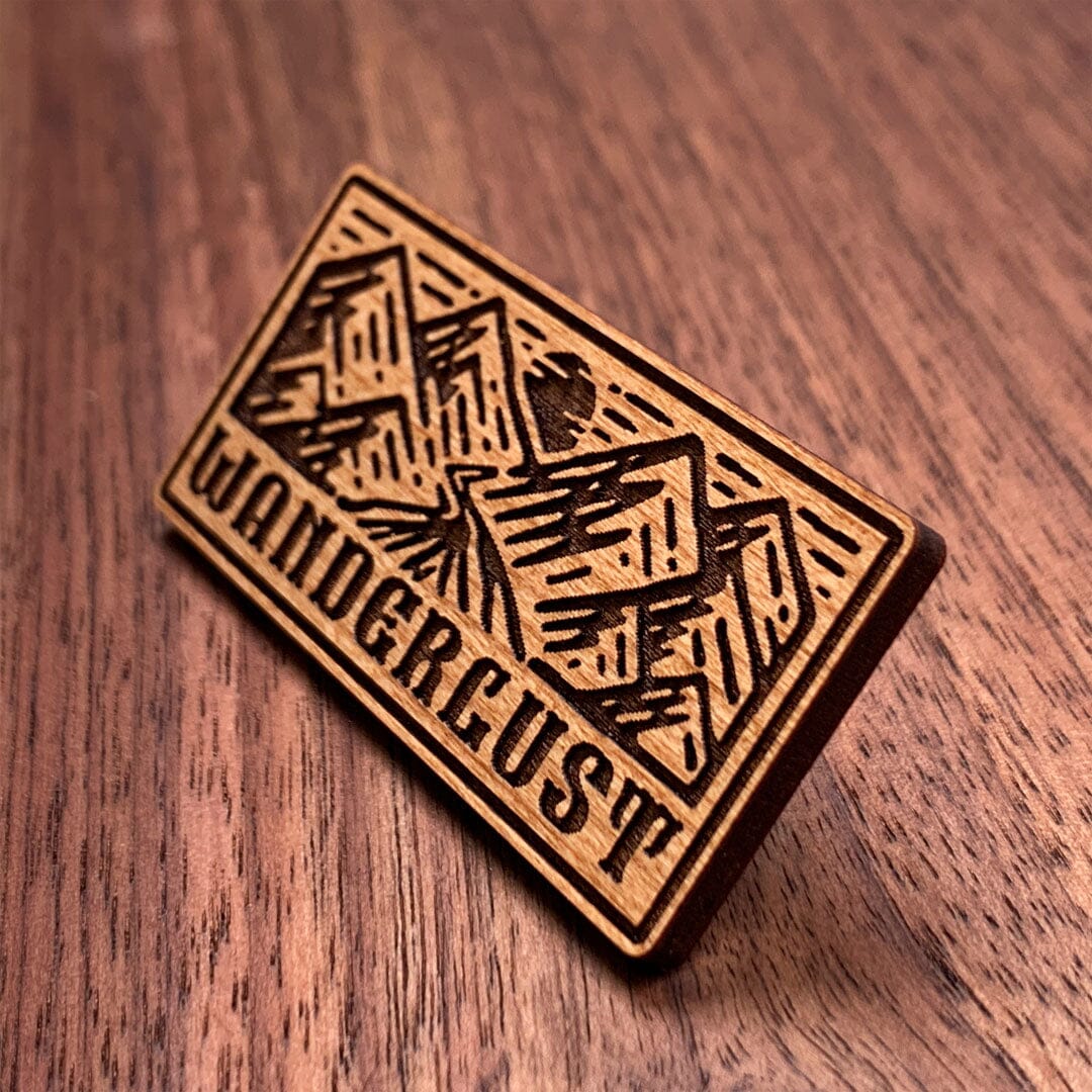 Wanderlust - Keyway Engraved Wooden Pin in Cherry, Zoomed in View