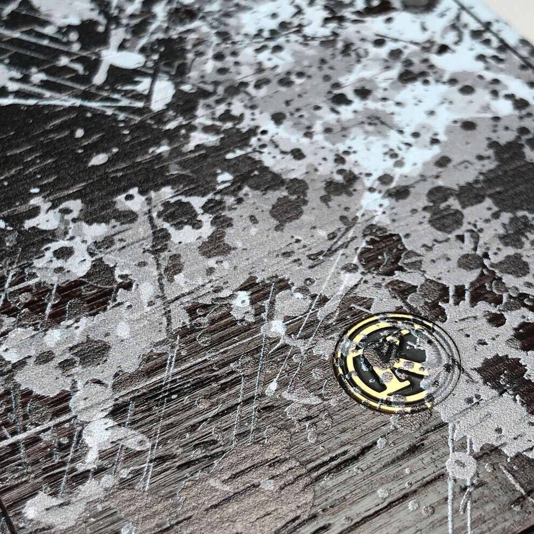 Zoomed in detailed shot of the aggressive, monochromatic splatter pattern overprintedprinted Wenge Wood iPhone XS Max Case by Keyway Designs