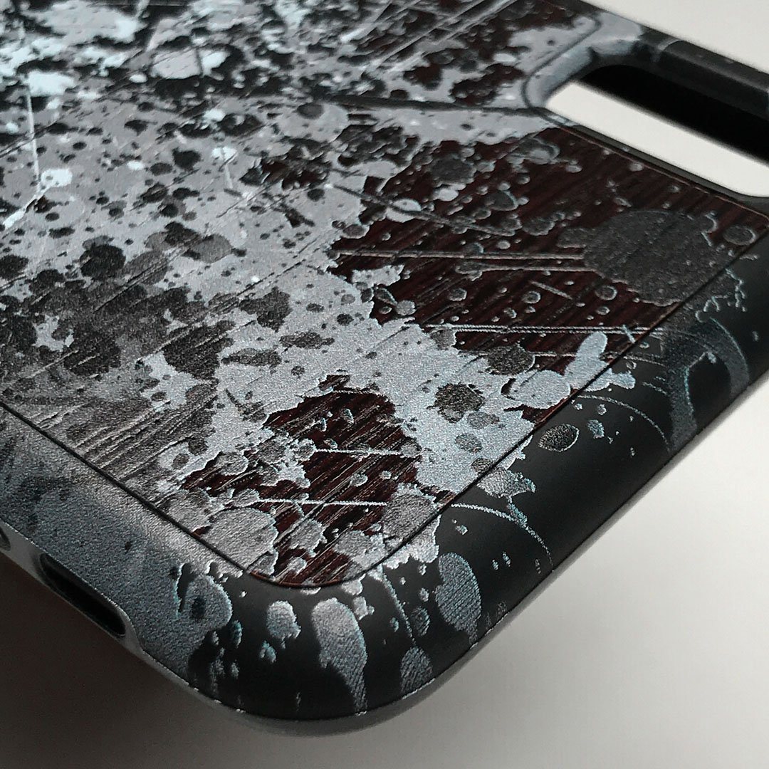 Zoomed in detailed shot of the aggressive, monochromatic splatter pattern overprintedprinted Wenge Wood iPhone XS Max Case by Keyway Designs
