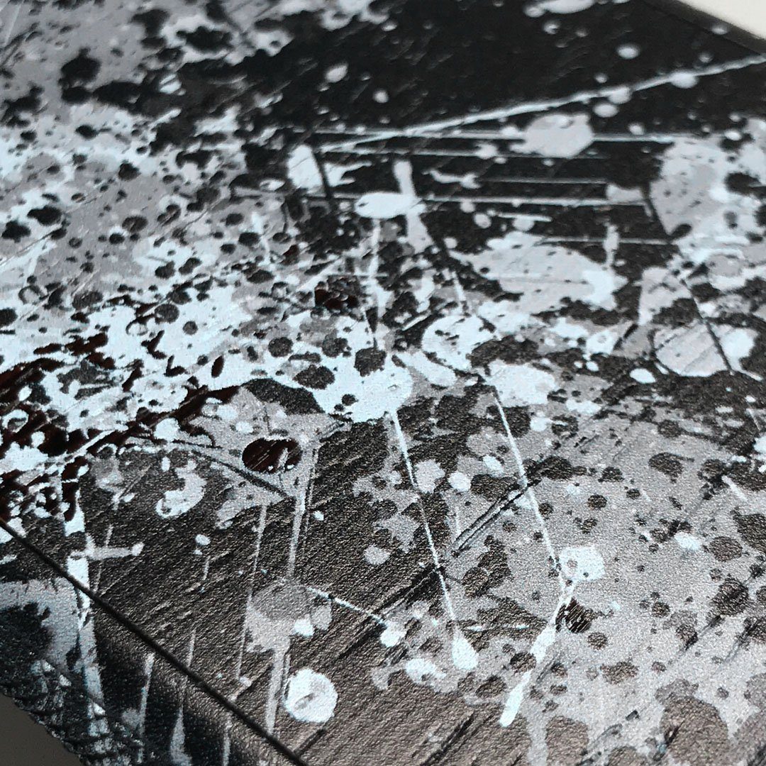 Zoomed in detailed shot of the aggressive, monochromatic splatter pattern overprintedprinted Wenge Wood Galaxy Note 10 Case by Keyway Designs